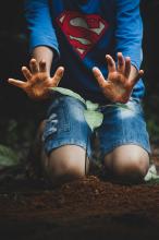 Superman planting plant.